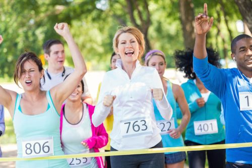 Charity runners crossing finish line