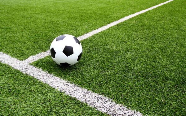 Football on grass pitch
