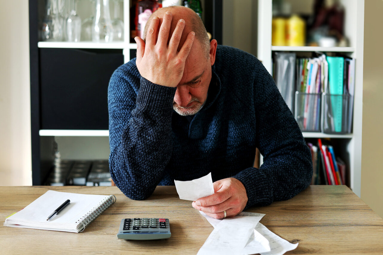 Man holding his head in his hands
